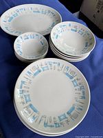 Group shot of platter, plates and bowls showing pattern
