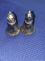 pair of tarnished silver-plate salt and pepper shakers