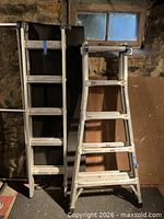 Folded Werner telescoping ladder standing upright