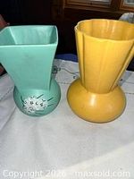 Two vases side by side: green McCoy and yellow York.