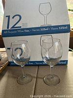 Two wine glasses in front of box marked 12 pieces 325 ml