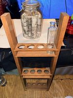 Wood rack, large jar, one bottle visible