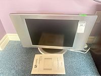 Front view of Audiovox FPE2000 LCD TV with accessories visible