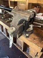 Front angled view of cast iron bench vise mounted on workbench