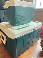 Thermos personal cooler stacked on Coleman large cooler showing both items