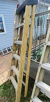 Full view of Featherlite fiberglass step ladder leaning against structure