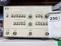 Front view showing model designation, control panel, buttons, knobs, BNC jacks, and power switch