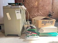 Side view of oscilloscope chassis, Digi-Key box, loose boards and components
