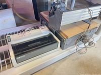 HP ThinkJet printer body next to aluminum rail assembly with motor and wires
