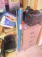 Full view of blue Knox projection screen in rolled position on tripod base