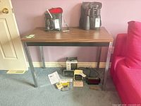 Full view of laminate table with items on and beneath it