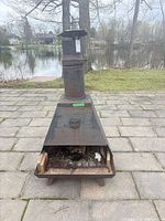Front view of rusted metal chiminea on patio