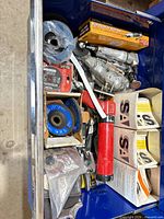 drawer view showing multiple pneumatic tools, flap discs, boxed abrasives and fittings