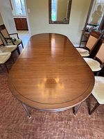 Full view of oval dining table with chairs surrounding