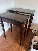 Pair of nesting wood veneer end tables standing together