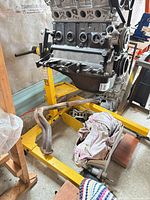Overall view of yellow steel engine stand supporting engine block