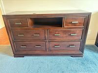 Front view showing all eight drawers and open shelf