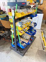 Front view of steel rack with multiple rows of yellow and blue bins
