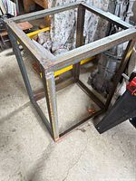 Full view of steel square-tube frame standing on floor