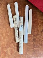 Six rolled maps on floor showing overall quantity and rolled condition