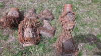 All four wooden and coir fibre sculptures laid out on grass