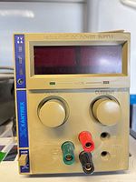 Front view of Xantrex bench power supply showing display, knobs, output terminals, 7 V 6 A rating