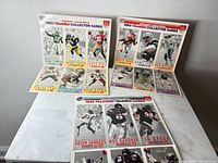 Three uncut card sheets displayed front and back