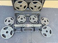 Open case with handle, 8 plates arranged around it on table