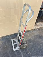 Full view of hand truck upright showing aluminum frame and wheels