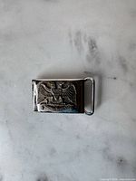 Front view of belt buckle showing Masonic double-headed eagle and 32 emblem