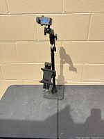 Full view of Arkon stand showing weighted base, pole and clamps