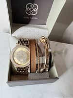 Watch and three bracelets in original box, front view