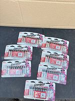Six blister packs of Energizer AA batteries laid out on table