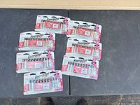 Six Energizer AA battery blister packs displayed on table