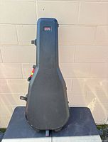 Closed black Gator molded guitar case front view