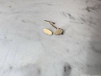 Cufflinks and tie tack overview on surface