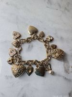 Full view of gold tone charm bracelet with all heart charms visible