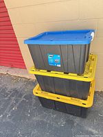 Stacked view of three HART totes showing colors and overall condition