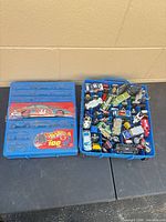 Closed case on left, open case on right showing assortment of cars