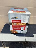 Factory-sealed Masterbuilt 30-quart turkey fryer kit in box, front panel showing product image and specs