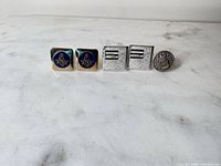 Front view of all cufflinks and tie tack