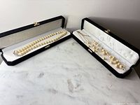 Both necklaces in individual black velvet cases