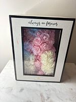 Foam rose bear visible through front window of gift box
