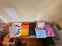 Overview of folded cotton fabric pieces showing variety of colours and prints