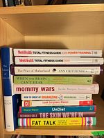 Single image of all eleven books on shelf showing titles and spines