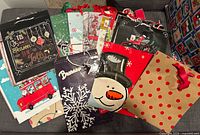 Front view showing variety of Christmas gift bags with different designs and handle types