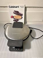 Waffle maker with instruction booklet visible