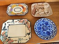All four ceramic items grouped on wood surface