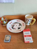 Full lot showing plate, two mugs, glass, card deck, keychain
