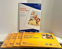 Front view of all six photo paper packs, showing brands, sizes and quantities